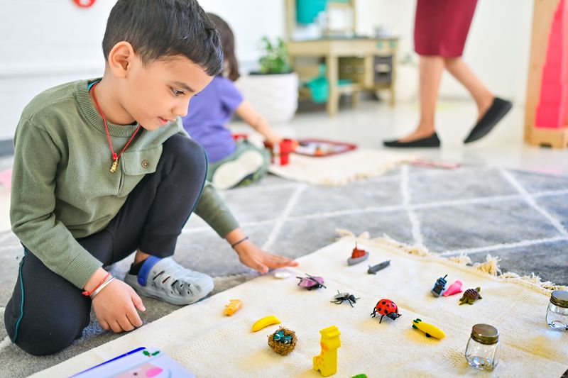 Child exploring Montessori science materials