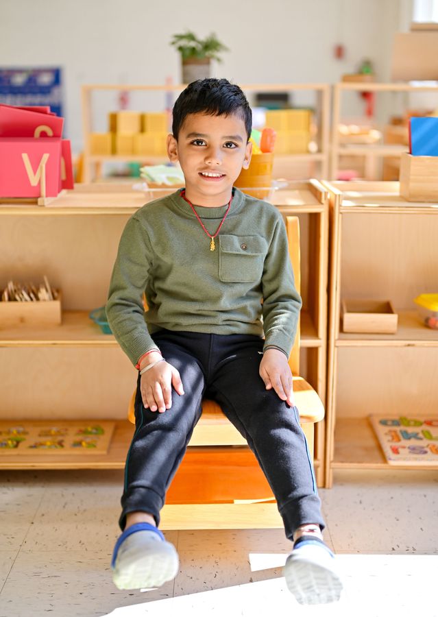 Confident child smiling in the Montessori classroom
