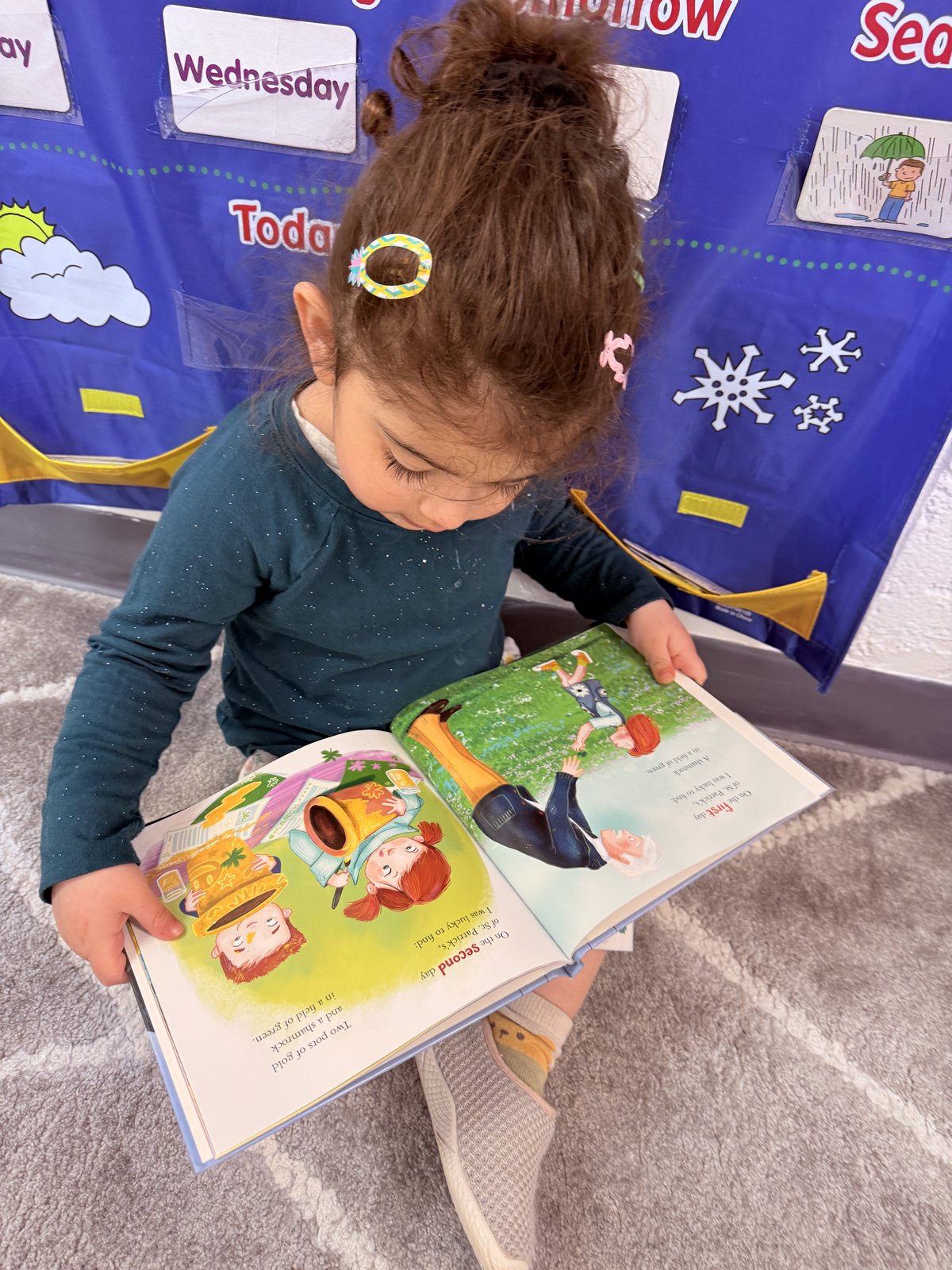 Child reading a picture book independently