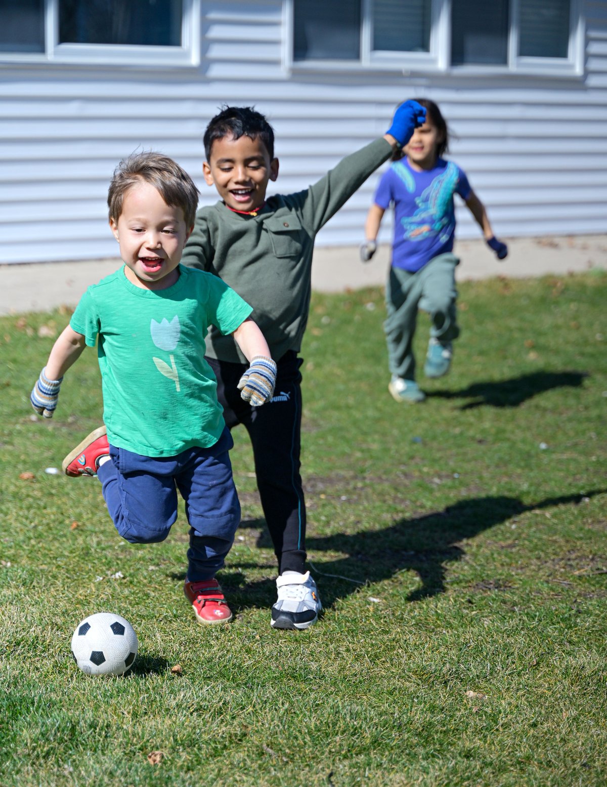 Student concentrating on a detailed Montessori language activity