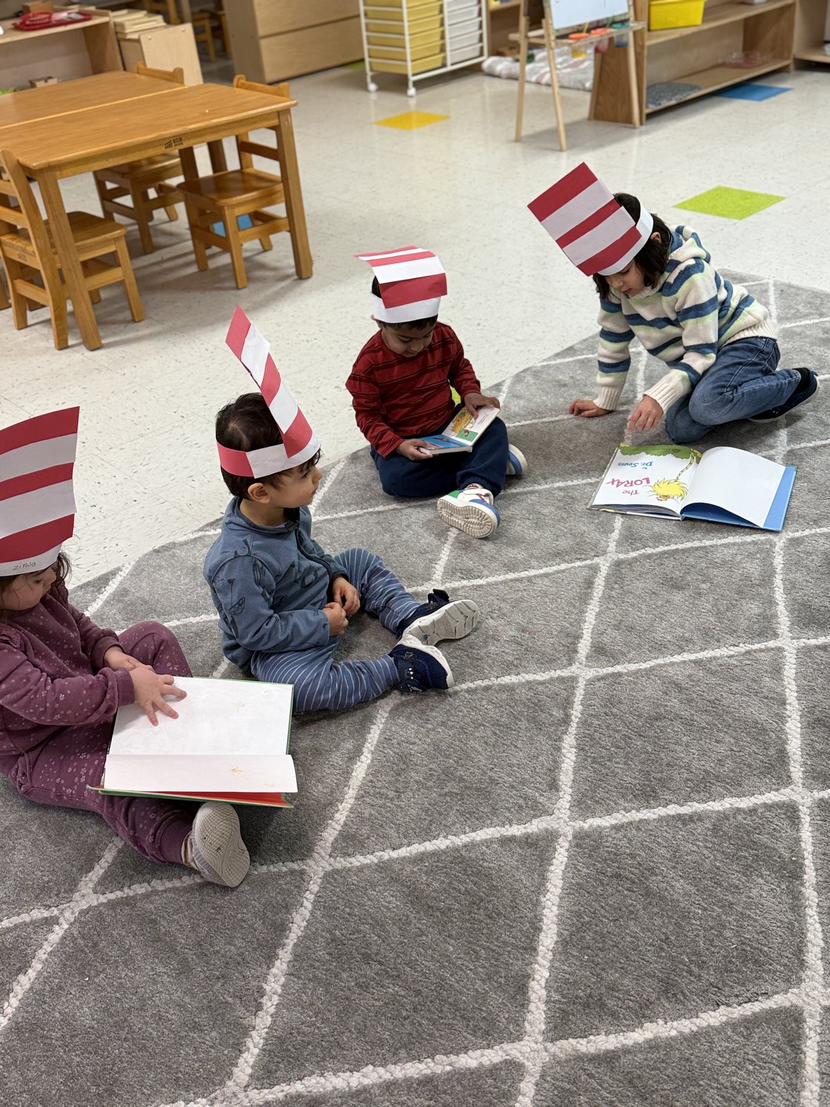 Two children laughing together during a classroom activity