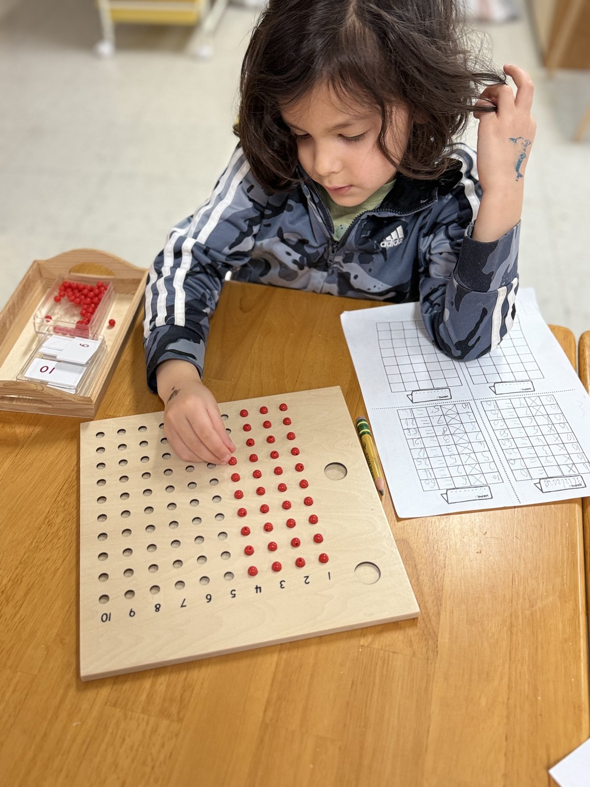 Child pouring and transferring as a practical life exercise