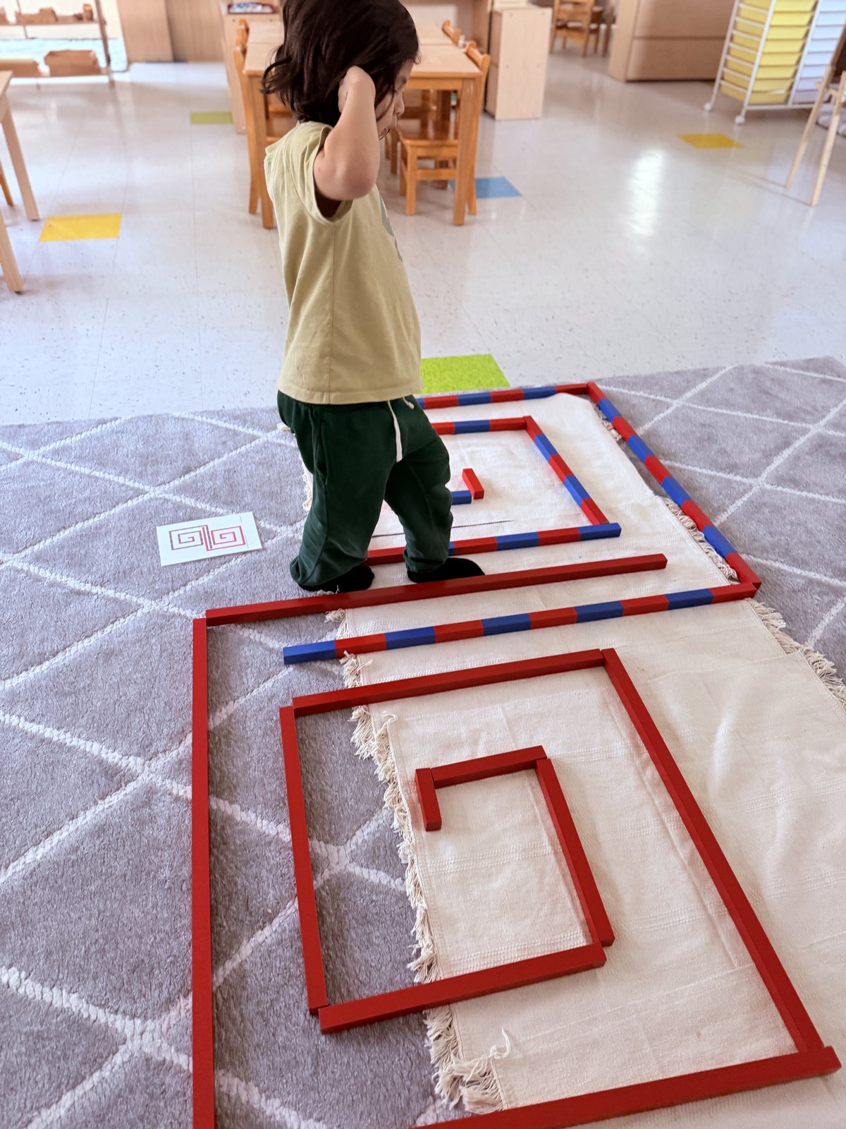 Two children working together on a group Montessori project