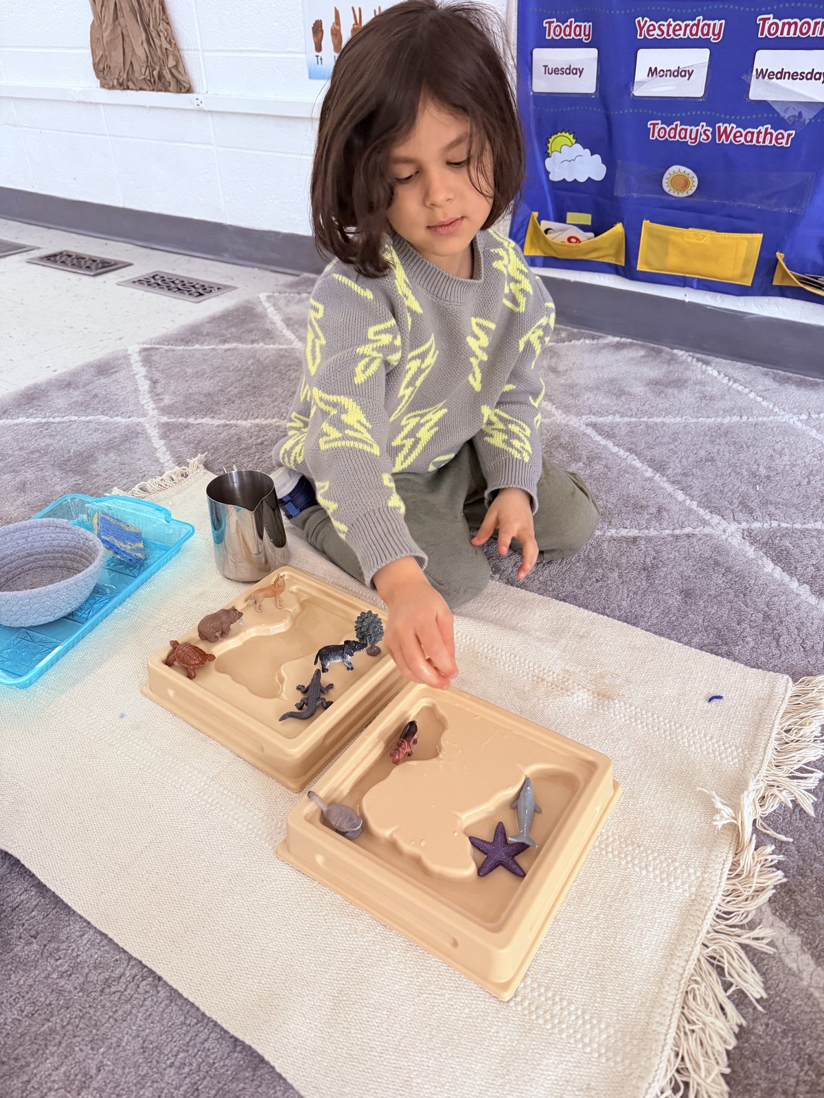 Child painting with brushes during a creative art session