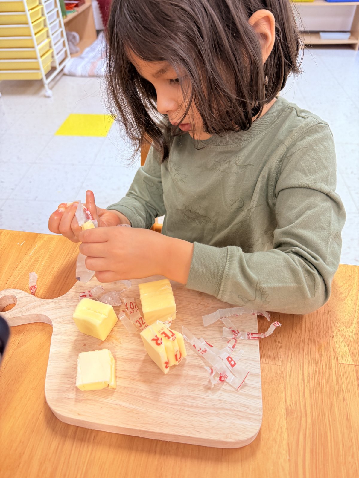 Student carefully arranging flowers in practical life work