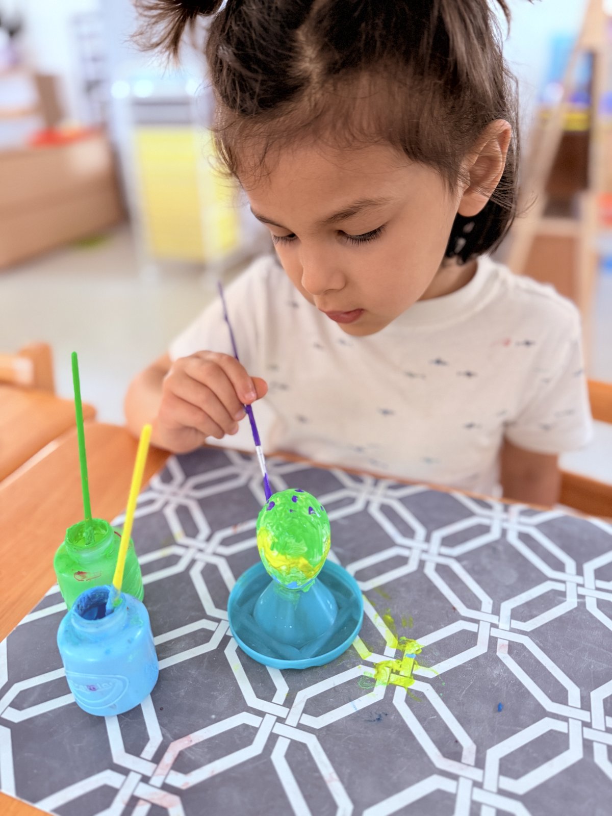 Student smiling after completing a Montessori work cycle