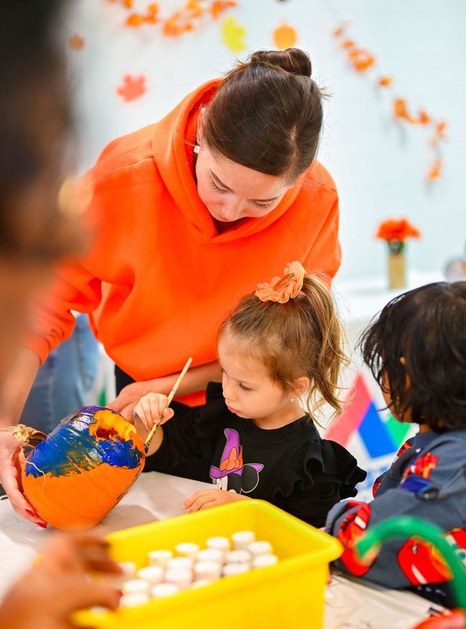Milestones Montessori teacher guiding a child in creative activity