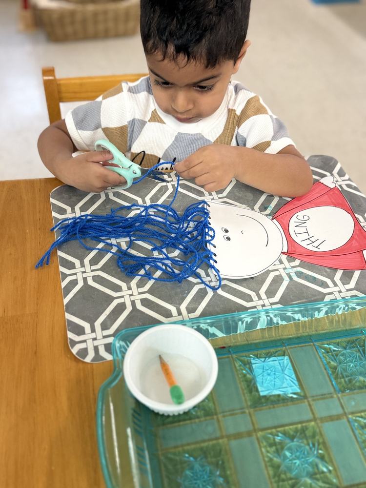 Child exploring creative art-making at their Montessori work station