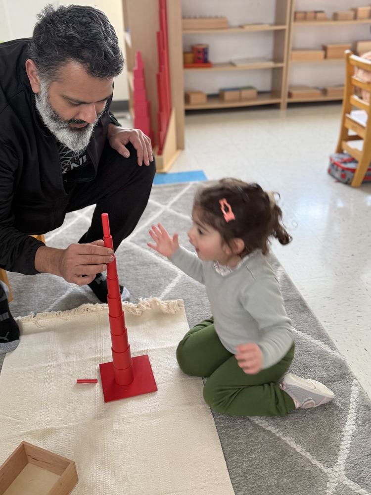Child working intently on a language or math Montessori activity