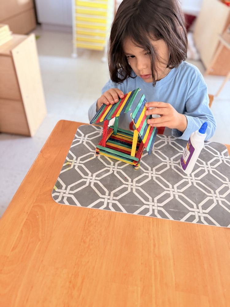 Child building with Montessori constructive triangle materials