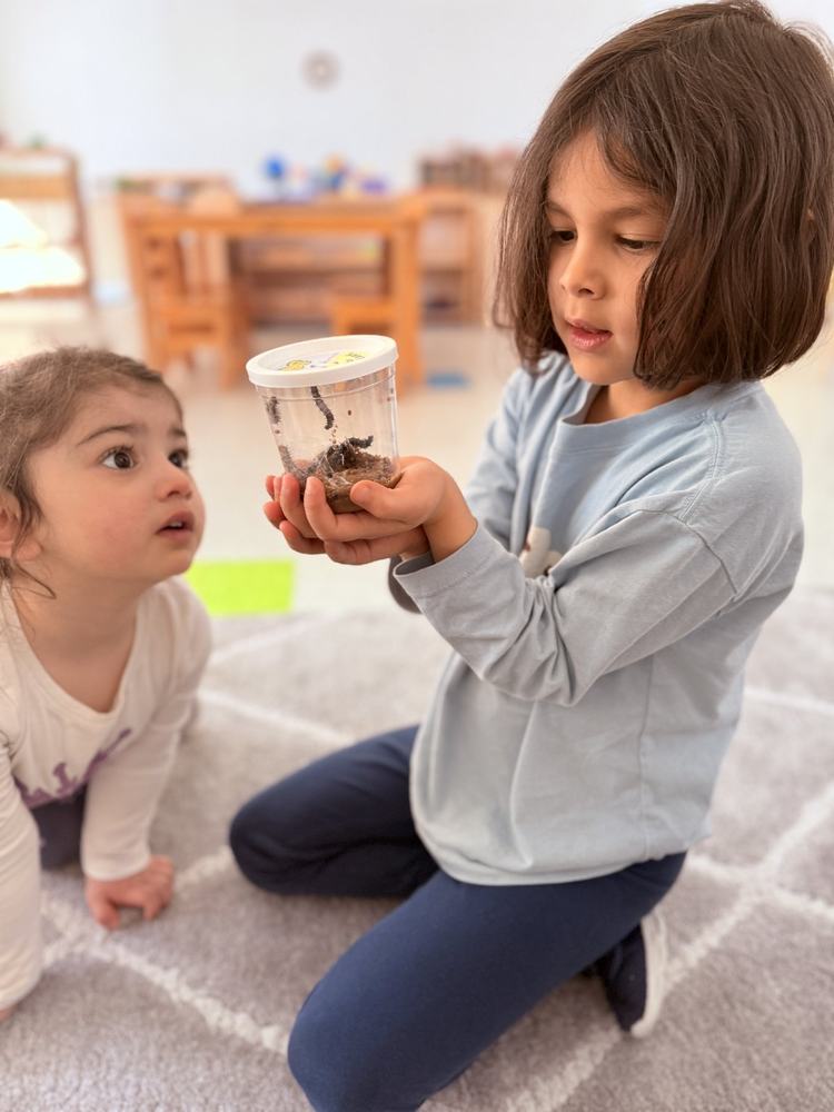 Child tracing sandpaper letters in the Montessori classroom